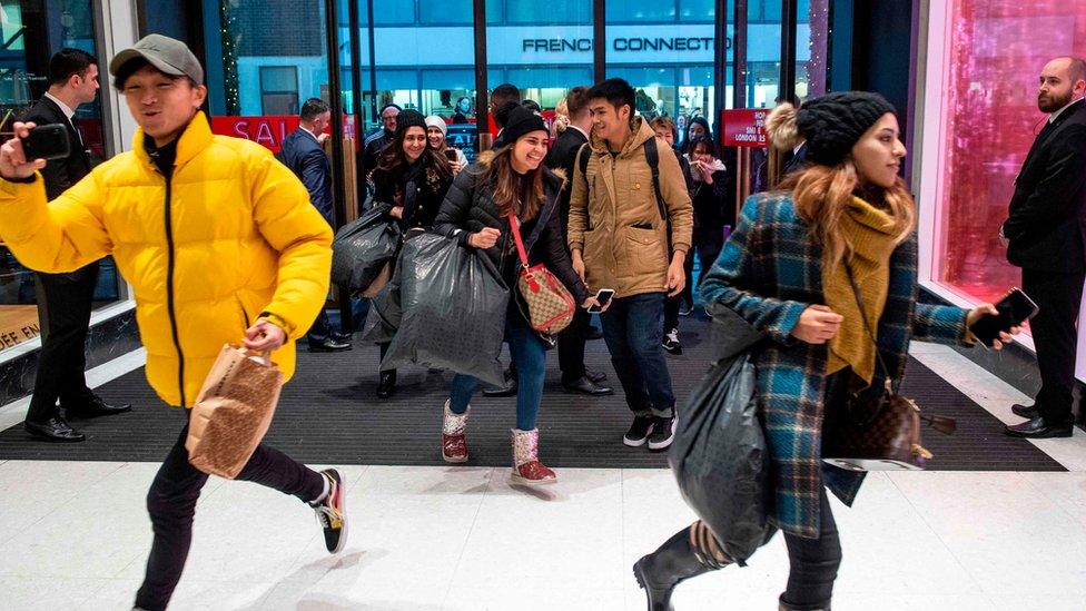 Shoppers running into Selfridges in London as the doors open