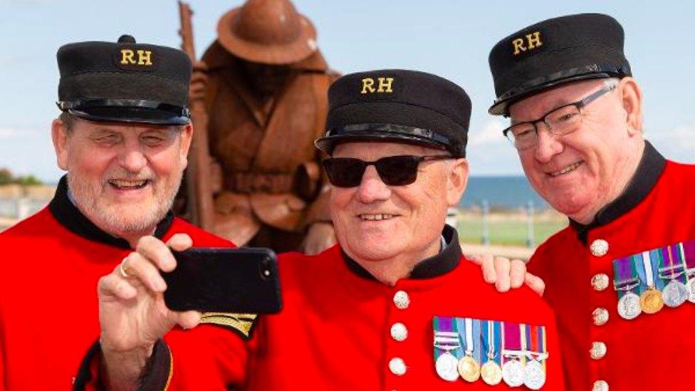 Fred Boomer-Hawkins taking a selfie with other Chelsea pensioners