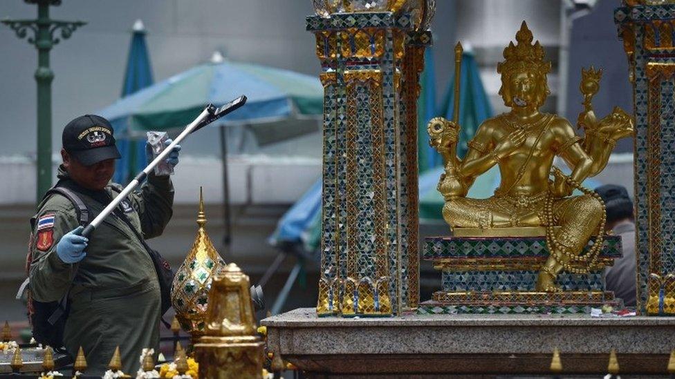 An EOD policeman inspects the cordoned-off site of a bomb blast at the popular Erawan shrine in the heart of Bangkok's tourist and commercial centre on August 18, 2015.