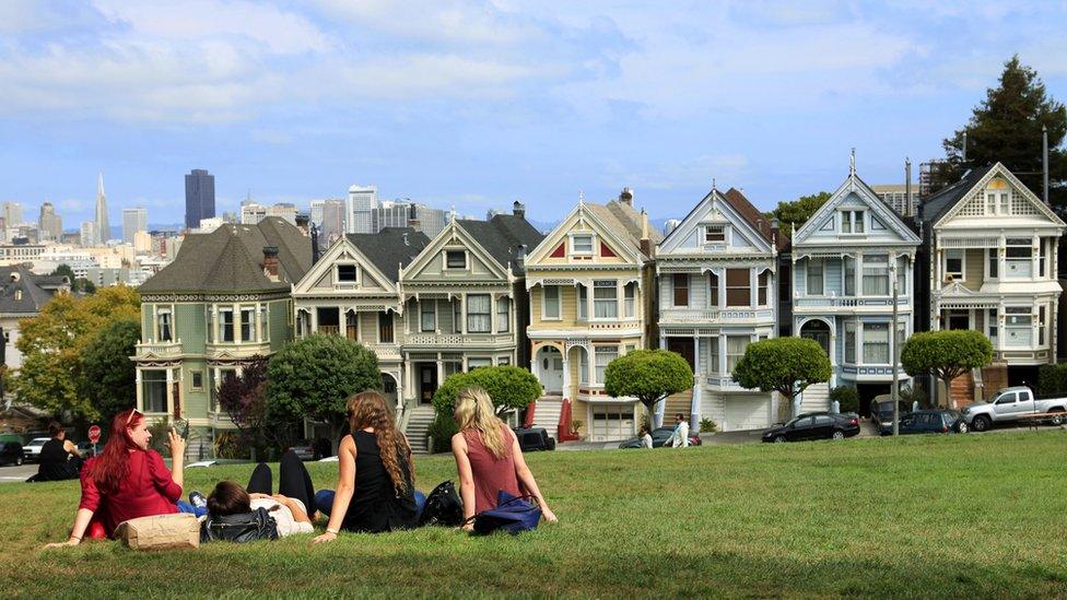 Group of girls sitting by housing