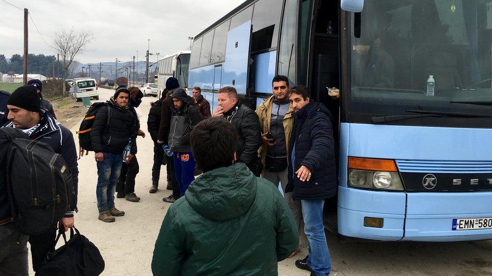 A bus waits to take migrants back to Athens (12 Jan)