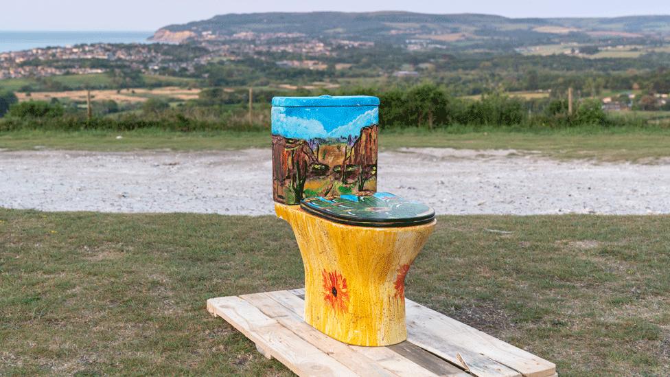 Desert imagery of cacti and Monument Valley-type cliffs adorns this loo, and the Isle of Wight coast is in the background.