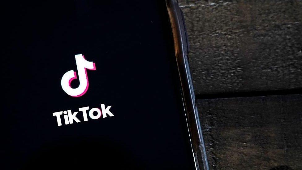 TikTok logo on a phone