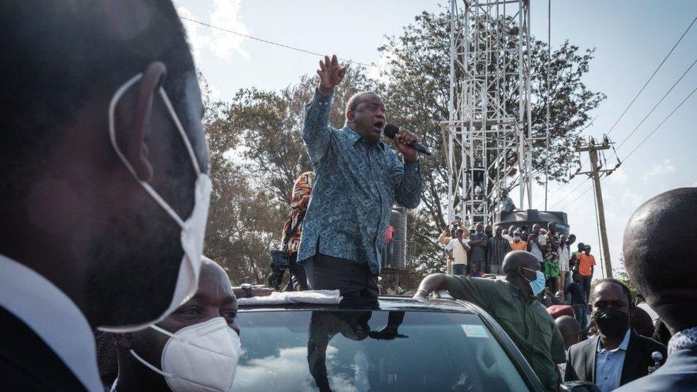 Kenya's President Uhuru Kenyatta (C) speaks to people after attending an inauguration of Kibra Level 3 hospital in Kibera slum in Nairobi on September 29, 2021.