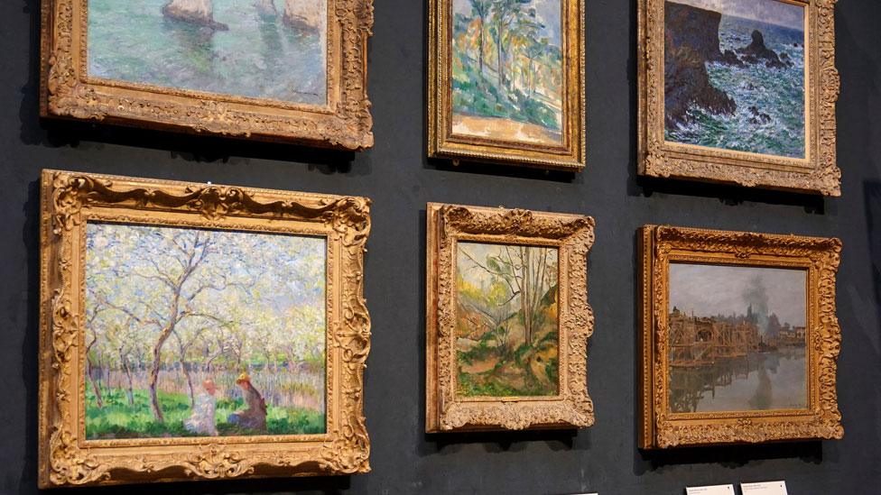 Six French impressionist paintings hanging on a dark grey background at Fitzwilliam Museum, Cambridge