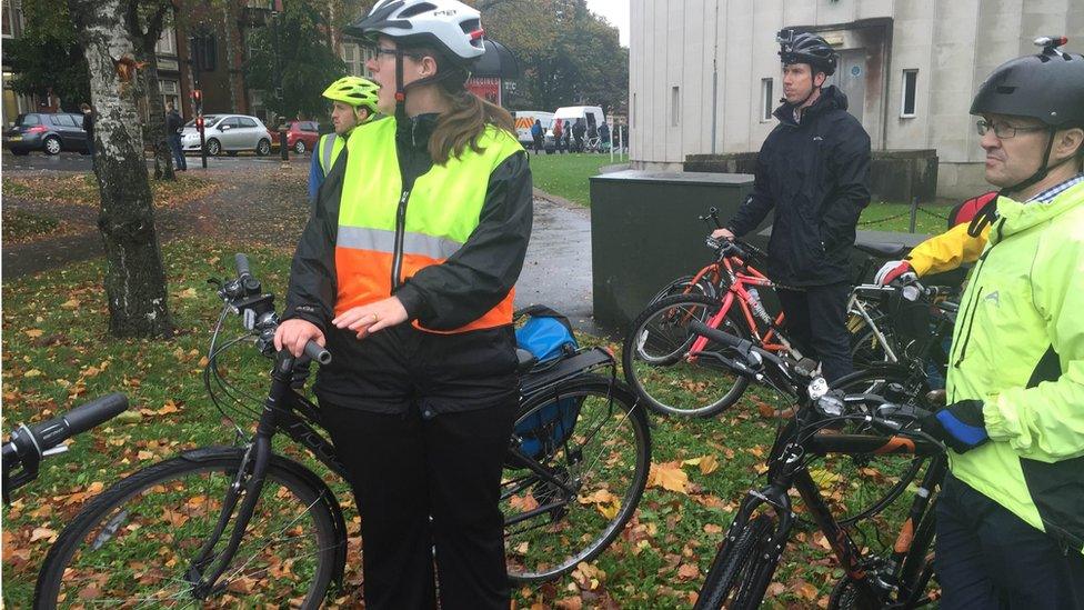 Group of cyclists waiting to cross road