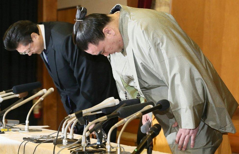 Mongolian grand champion, Harumafuji and his stable master Isegahama bow during a press conference to announce Harumafuji"s retirement on 29 November, 2017