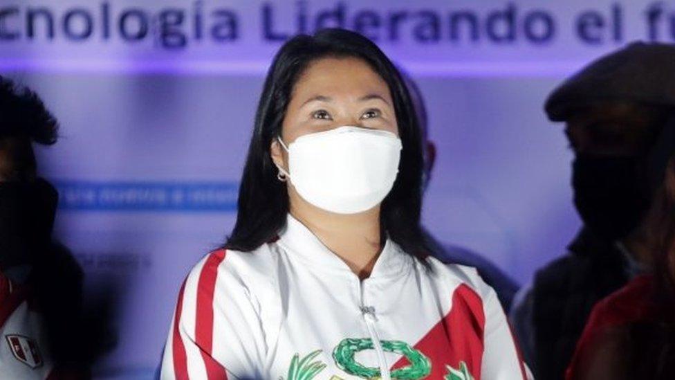 Peru's presidential candidate Keiko Fujimori (C) looks at supporters while leading a demonstration in Lima, Peru June 12, 2021