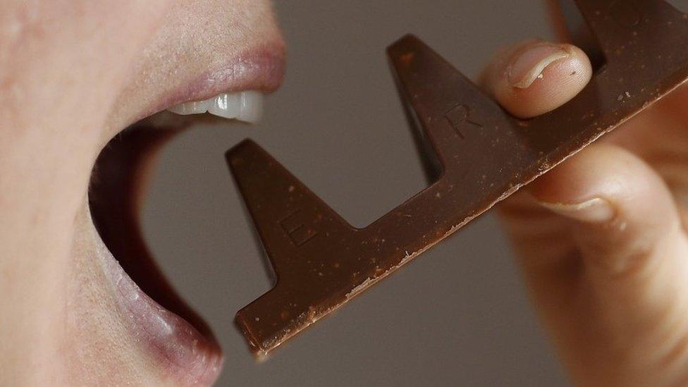 A woman bites into the new 150g bar