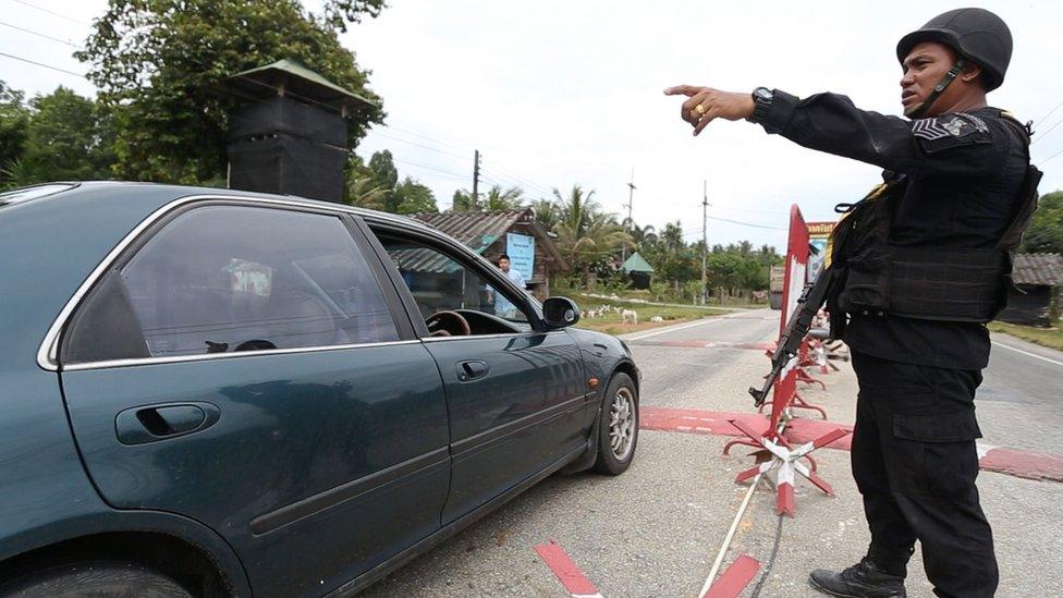 A car stops at a checkpoint in Narathiwat province.