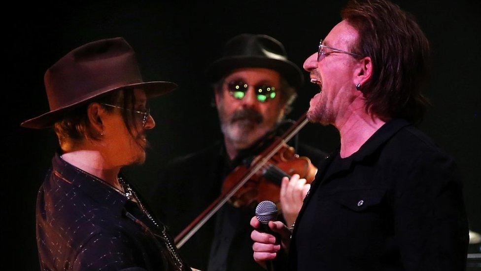 Bono and Jonny Depp perform