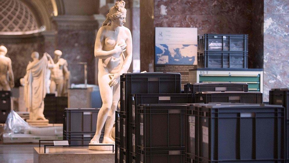 Artworks and crates in the Louvre