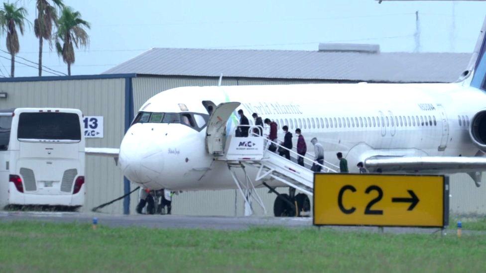 A plane being loaded with migrant children