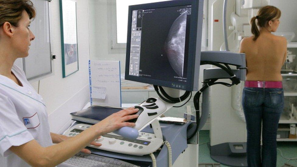 A woman having a mammogram