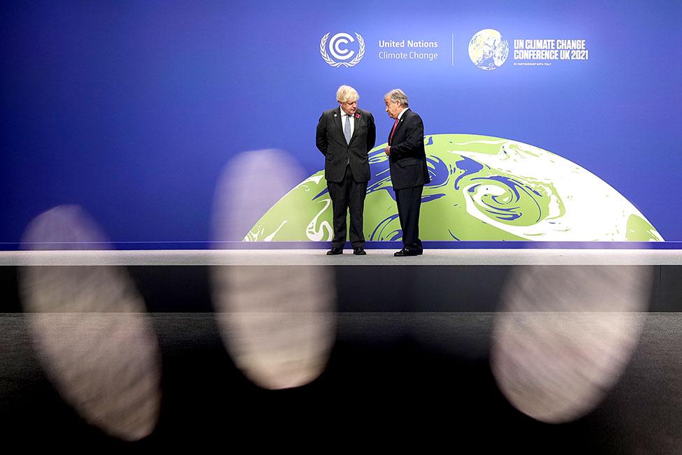 British Prime Minister Boris Johnson (left) and UN Secretary-General Antonio Guterres wait to receive attendees during day two of COP26 at SECC on 1 November 2021 in Glasgow, Scotland