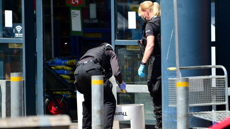 Two officers investigate the scene