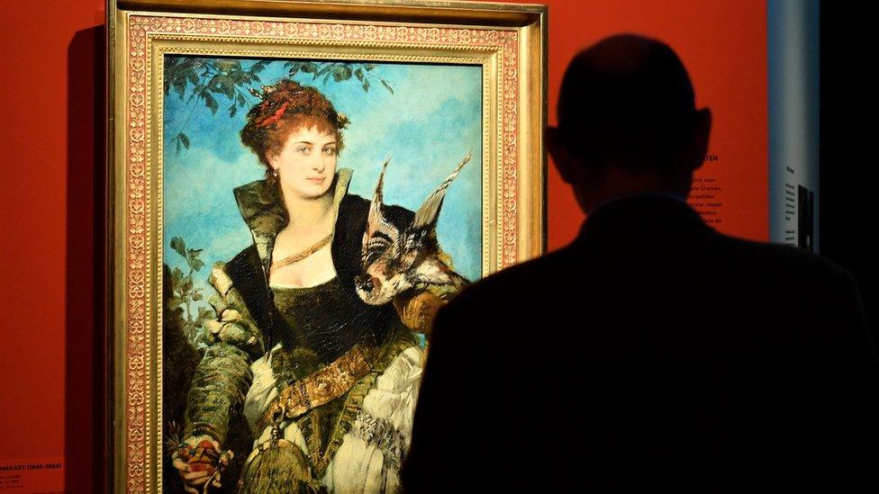 A visitor looks at a painting entitled The Falconer by Austrian artist Hans Makart, on display in the exhibition "Gurlitt: Status Report Nazi Art Theft and its Consequences" at the Art and Exhibition Hall of the Federal Republic of Germany (Bundeskunsthalle) in Bonn, Germany, 2 November 2017