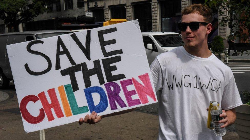 A person wears a t-shirt with the anagram WWG1WGA, the QAnon slogan, while participating in a "save the children" march and rally in New York City, New York, U.S. August 12, 2020