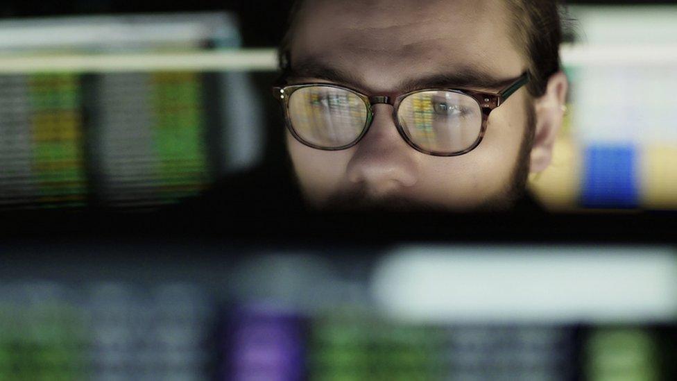 Young man working at a computer screen