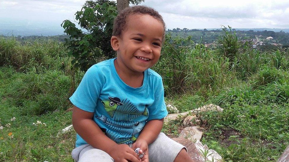 A boy sitting in a field