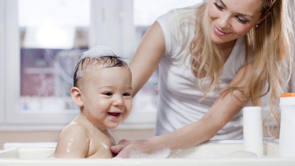 Baby being given a bath