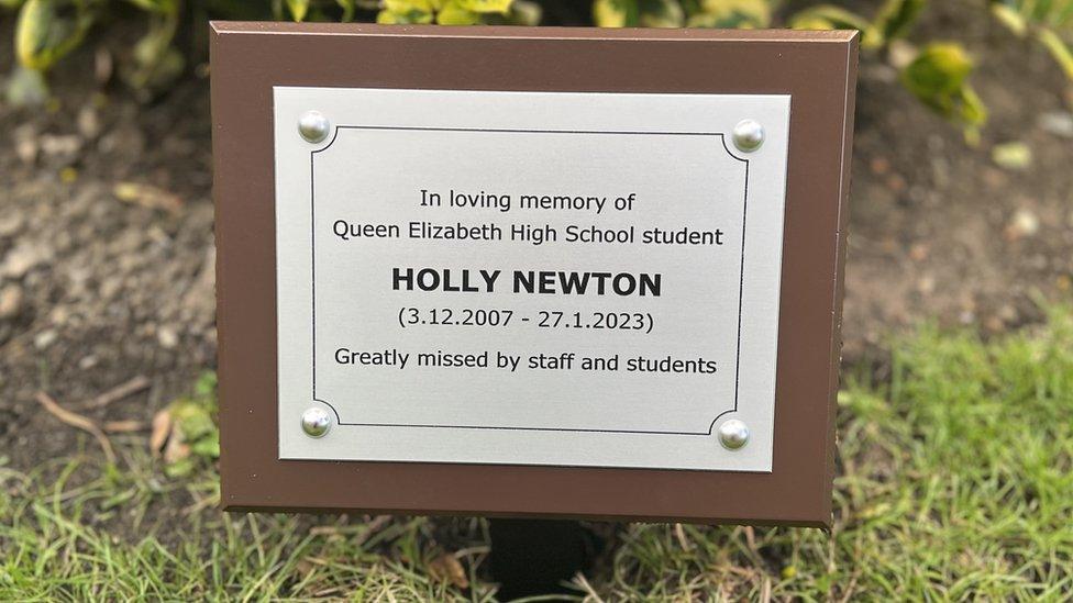 A memorial plaque dedicated to Holly