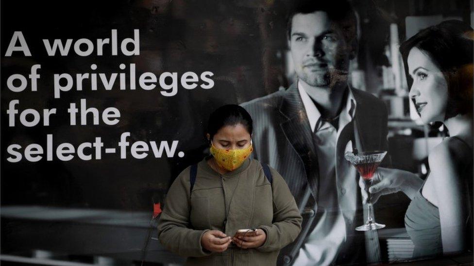 An Indian commuter wears a protective mask as she waits next to a vaccination center in Kolkata, India, 03 February 2021.