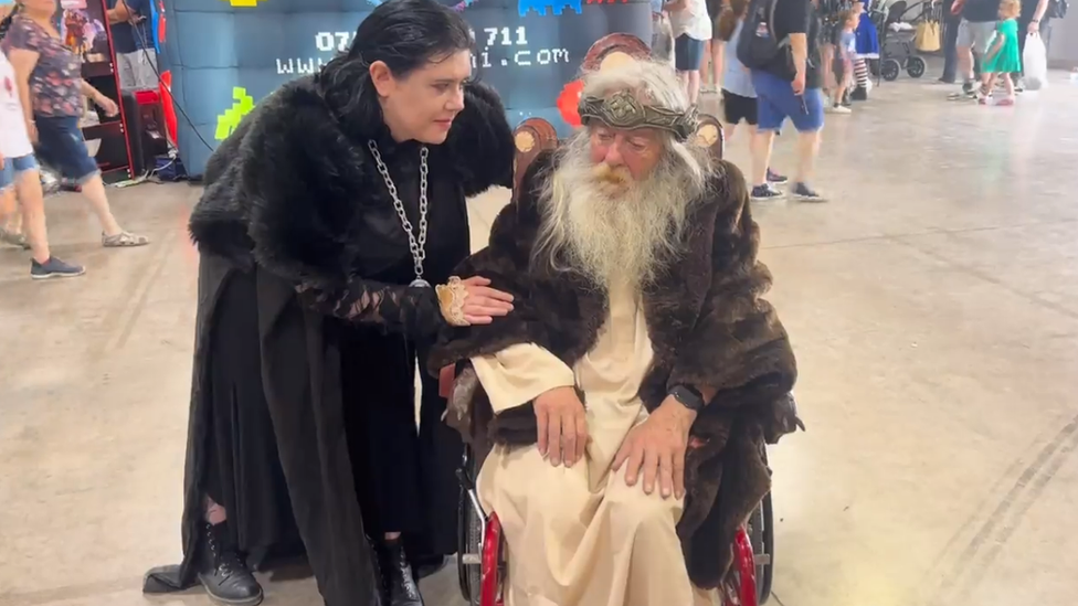 Two cosplayers as King Theoden and Wormtongue