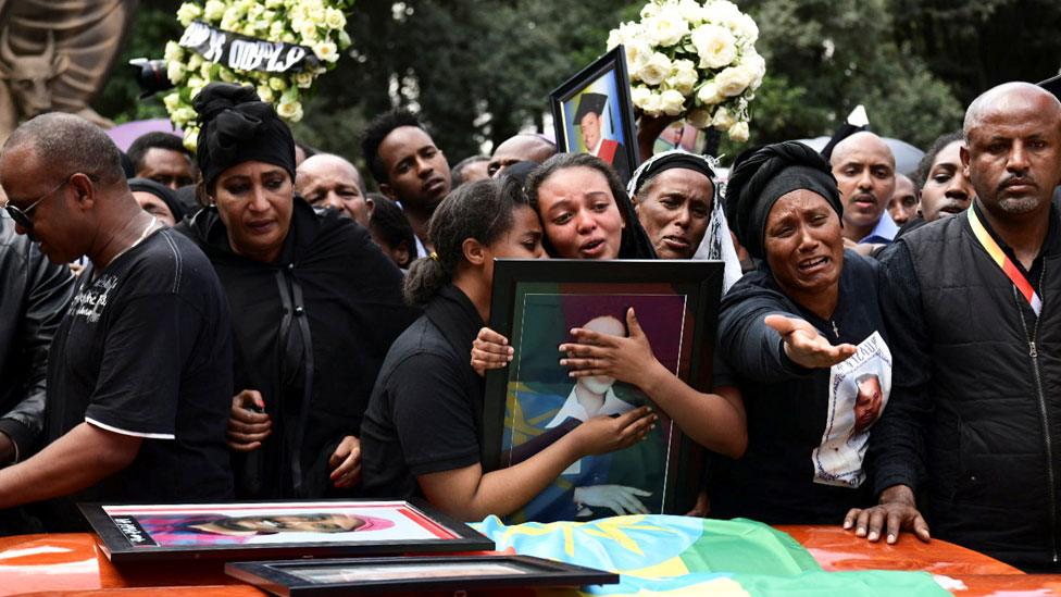 Relatives mourn next to the coffins of Ethiopian passengers and crew members, during a memorial service for the victims of the Ethiopian Airlines Flight ET 302 plane crash, at the Selassie Church in Addis Ababa, Ethiopia March 17, 2019.