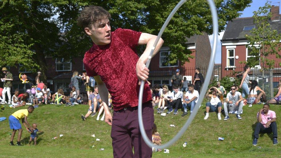 Man with hula hoop in carnival park