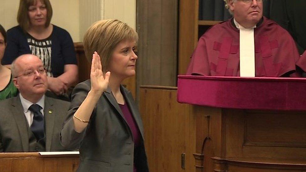 Nicola Sturgeon with hand raised to take oath