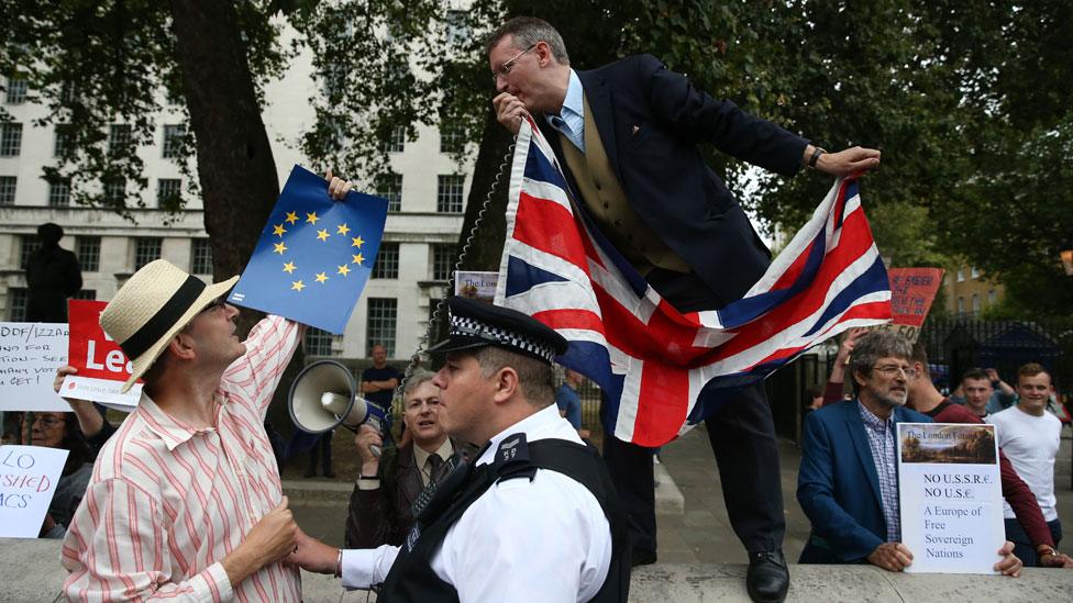 A police officer separates Remain and Leave activists in Parliament Square, September 2016