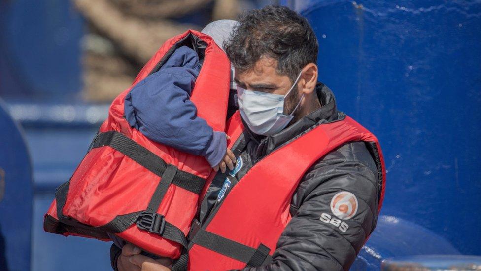 Migrants arrive after crossing the English Channel in Dover