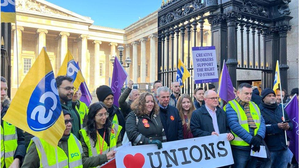 PCS picket line outside the British Museum holding flags and posters