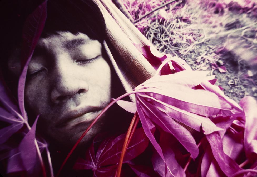 Youth Wakatha u thëri, a victim of measles, is treated by shamans and paramedics from the Catholic mission in Catrimani, Roraima, 1976.