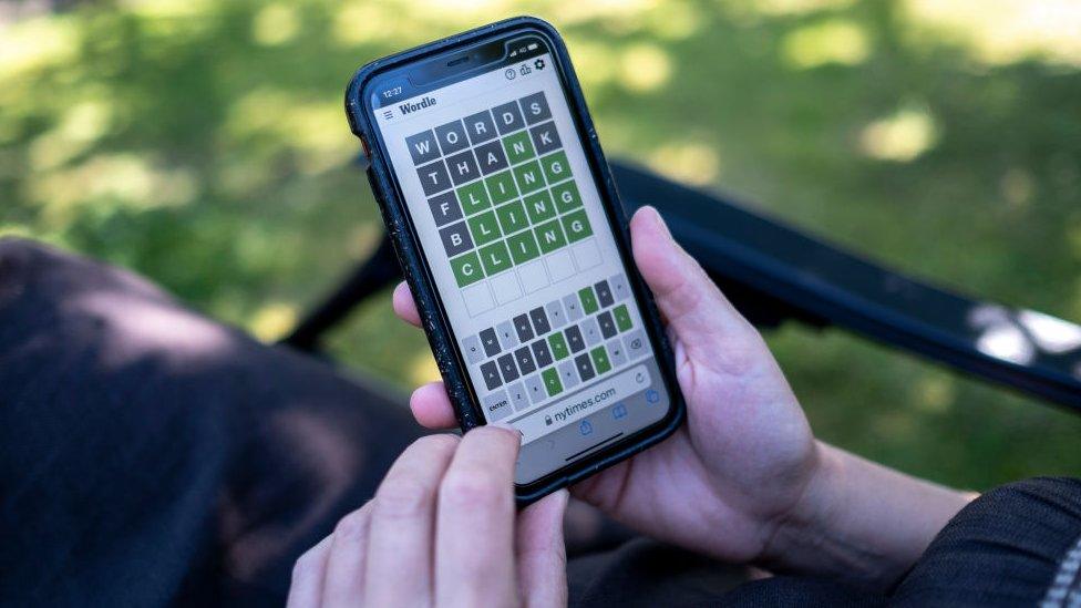 Person playing wordle on smartphone