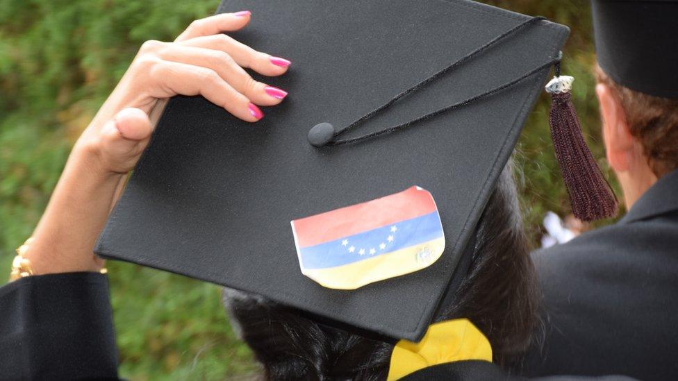 An upside-down Venezuelan flag can be seen pinned to a mortar board at a graduation ceremony at the University of the Andes