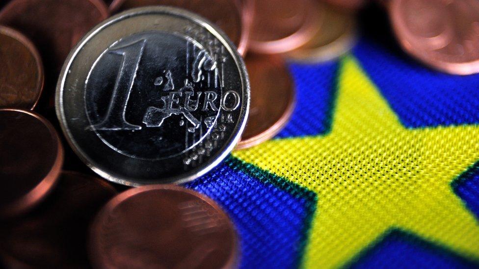 euro and euro-cents coins on EU flag