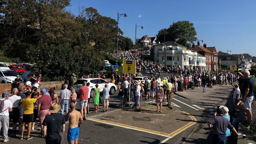 People line the streets to watch the Tour of Britain