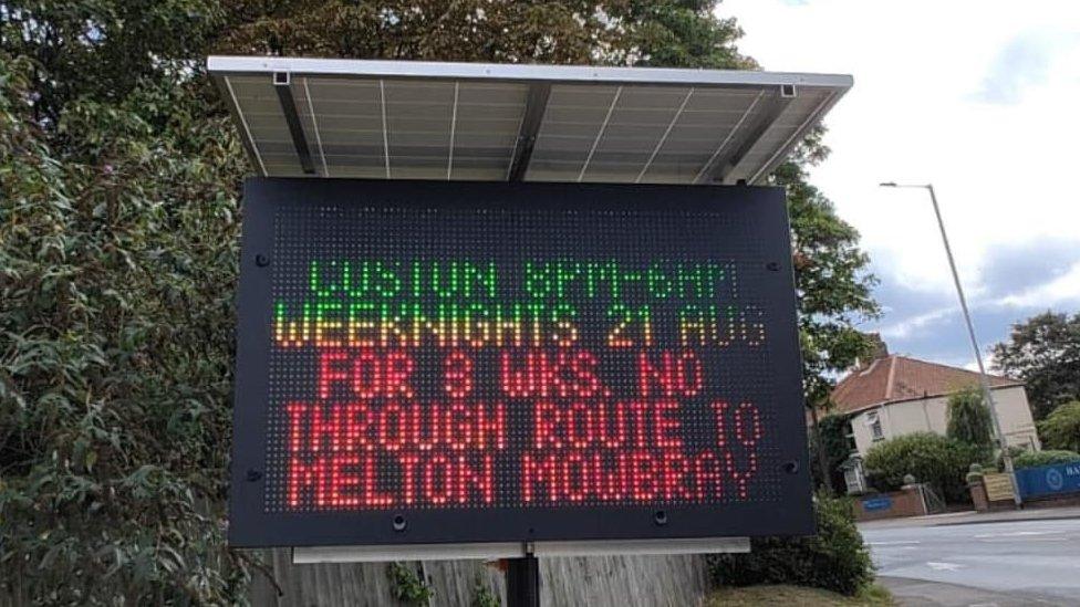 An electronic road sign in Norwich displaying information for roadworks in Leicstershire.