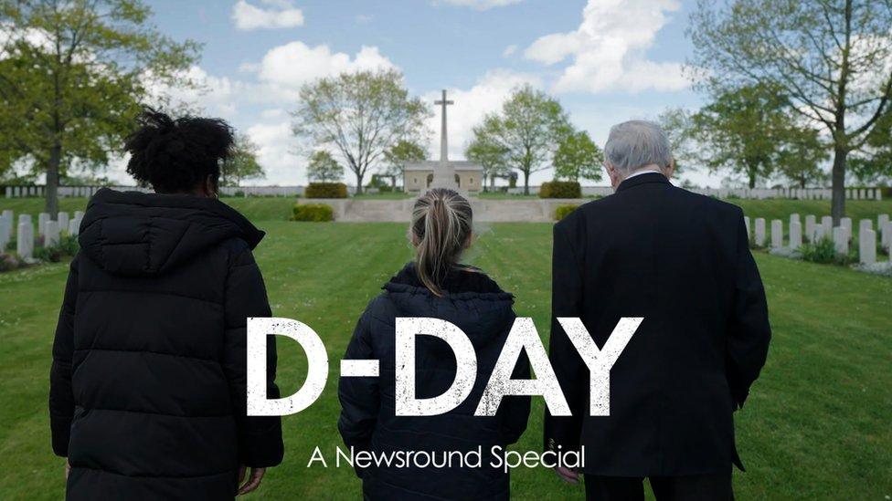 Emma-Louise with Lyra and Arthur at a cemetery in Normandy. All three have their backs to the camera and are walking towards a war memorial