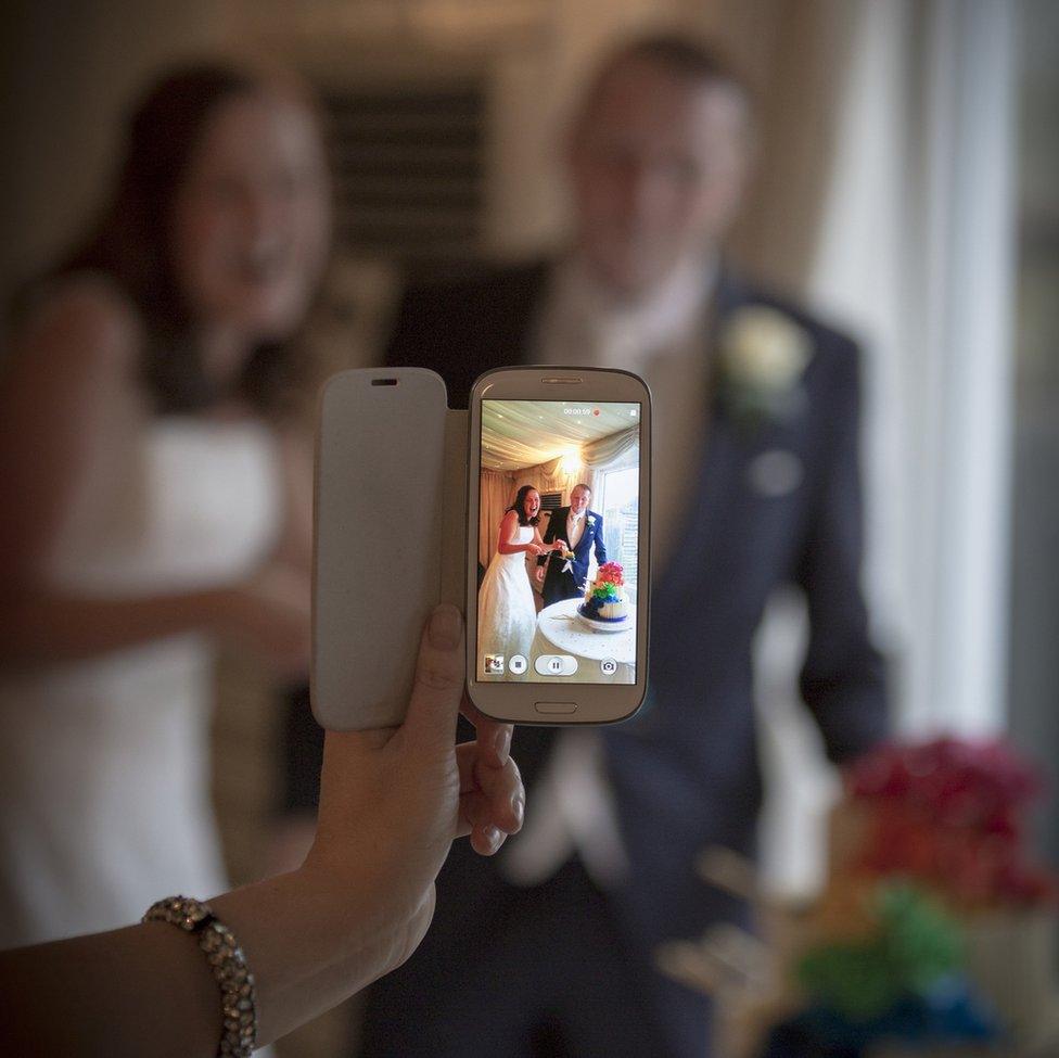 Wedding couple photographed with a mobile phone