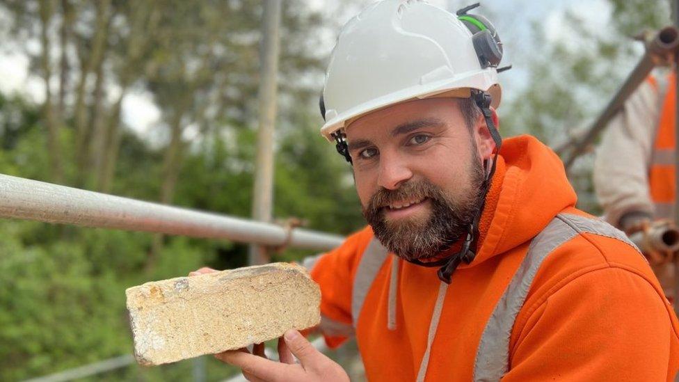 Jack Ford holding a brick