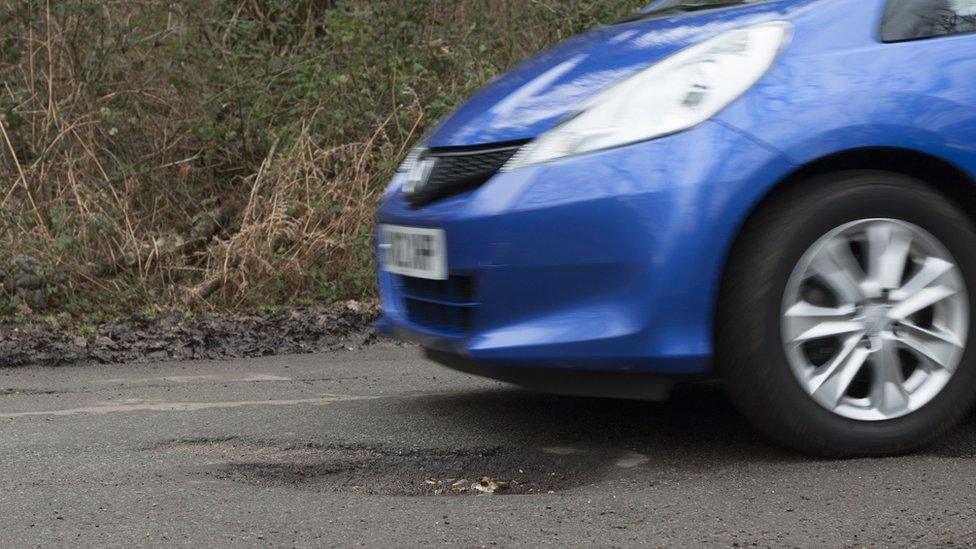 A car about to drive over a pothole