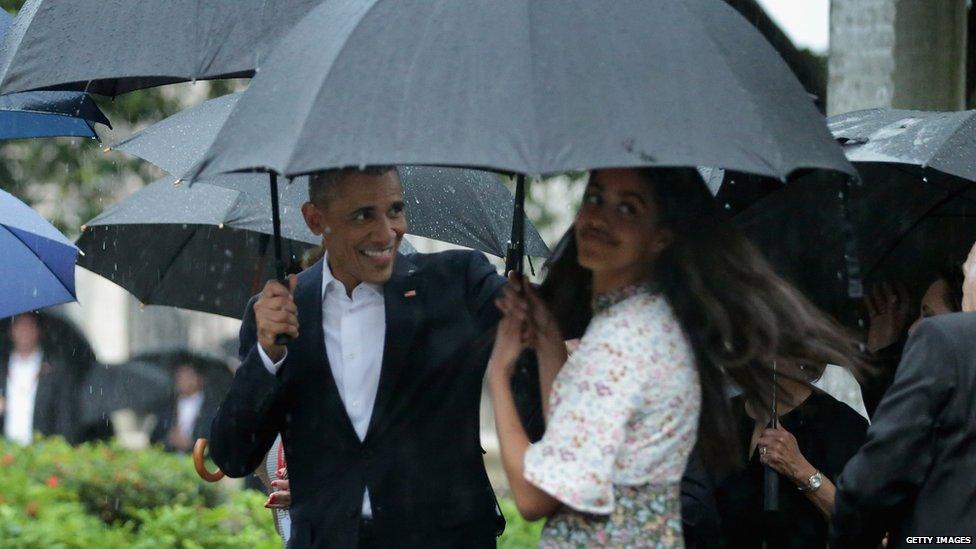 Barack Obama and Malia Obama get caught in the Cuban rain