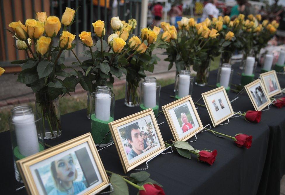 Pictures of Santa Fe school shooting victims stand by white candles and yellow roses