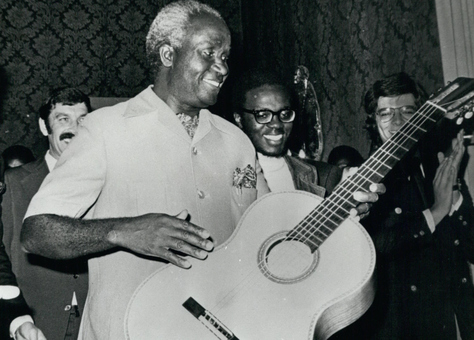 Zambia's President Kaunda playing the guitar on a visit to Portugal in 1975