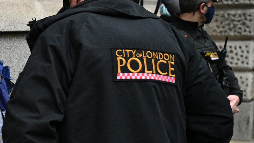 A City of London badge on the back of an officer's jacket