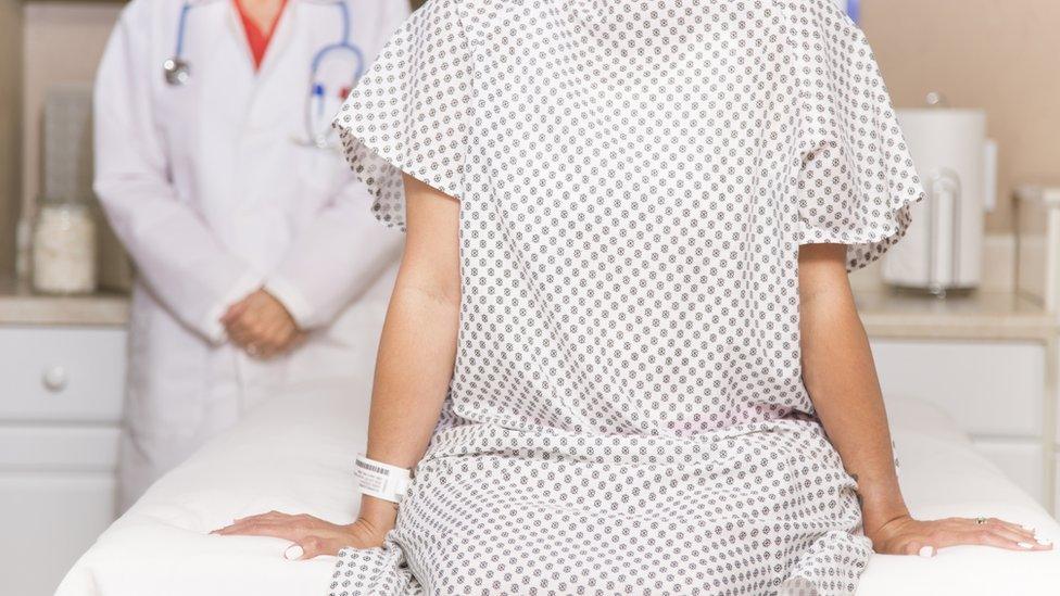 Stock photo of woman in hospital gown