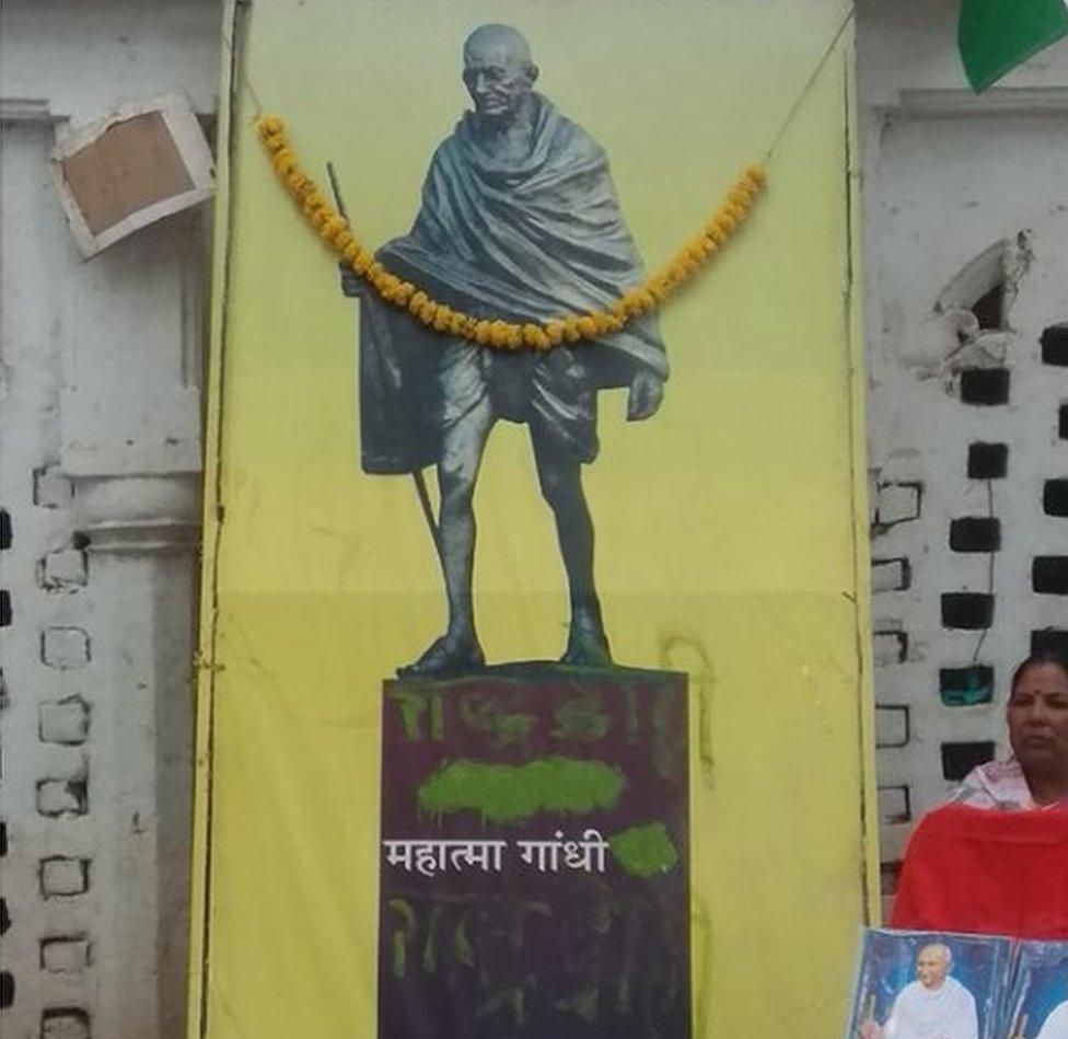 The poster with green paint on it at the memorial